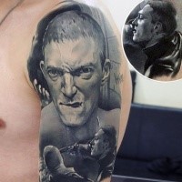 Portrait style colored shoulder tattoo of mad man face with pistol