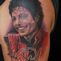 Portrait style colored shoulder tattoo of Michael Jackson face with signature