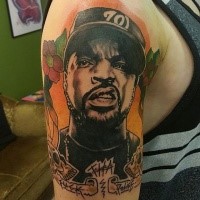 Portrait style colored shoulder tattoo of famous American singer face and lettering