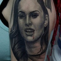 Portrait style colored shoulder tattoo of vampire woman face