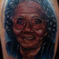 Portrait style colored tattoo of old woman face