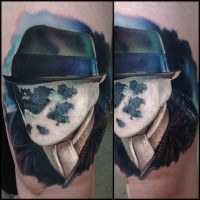 Portrait style colored thigh tattoo of Rorschach portrait