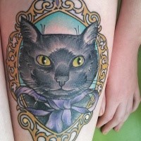 Portrait style colored thigh tattoo of cat with violet bow