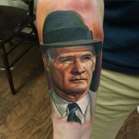 Portrait style colored very detailed arm tattoo of old man face