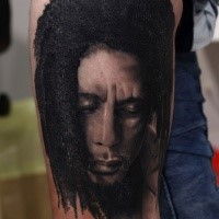 Portrait style detailed arm tattoo of famous musician