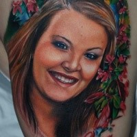 Portrait style very beautiful looking shoulder tattoo smiling woman with flowers