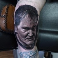 Portrait style very detailed and colored biceps tattoo of angry man face