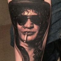 Portrait style very detailed arm tattoo of Slash face