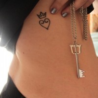 Pretty heart and crown tattoo on ribs