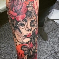 Psychedelic like colored forearm tattoo of woman portrait with flowers