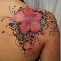 Purple-pink hawaiian flower with interesting curls tattoo on shoulder