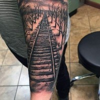 Railway in forest detailed realistic tattoo on arm