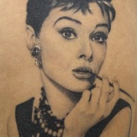 Real photo like black and white beautiful Audrey Hepburn portrait tattoo on thigh