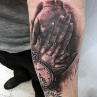 Real photo like black and white old clock with family hands tattoo on arm