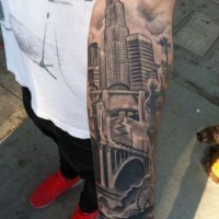 Real photo like black ink forearm tattoo of city sights