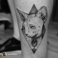 Real photo like dot style leg tattoo of sphinx cat with jewelry