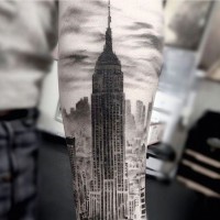 Real vintage photo like black and white forearm tattoo of Empire State Building