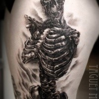 Realism style big detailed thigh tattoo of human skeleton