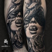 Realism style black and white forearm tattoo of woman with mask and rose