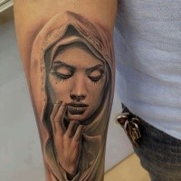 Realism style black and white forearm tattoo of woman in hood