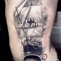 Realism style black and white large side tattoo of sailing ship with compass