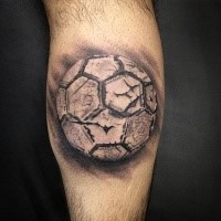 Realism style black and white leg tattoo of corrupted ball