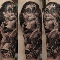 Realism style black and white shoulder tattoo of terrifying woman with butterfly