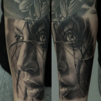 Realism style black and white woman portrait tattoo