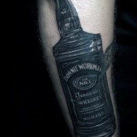 Realism style black ink arm tattoo of expansive whiskey bottle
