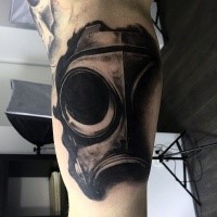 Realism style black ink biceps tattoo of gas mask part