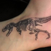 Realism style black ink small foot tattoo of dinosaur skeleton