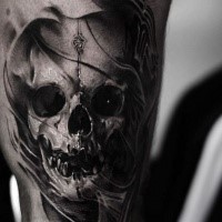 Realism style black ink tattoo of fantasy skull with symbol