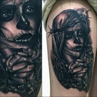Realism style black ink thigh tattoo of woman with mask and vine