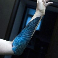 Realism style blue colored forearm tattoo of birds wing