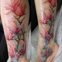 Realism style colored ankle tattoo of various flowers
