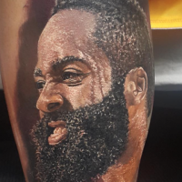 Realism style colored arm tattoo of angry man with beard