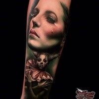 Realism style colored arm tattoo of crying woman with clown woman