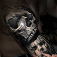 Realism style colored arm tattoo of human skull with woman face