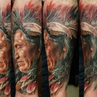 Realism style colored arm tattoo of old Indian with feather