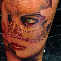 Realism style colored arm tattoo of woman with mask