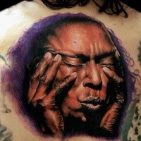 Realism style colored back tattoo of ancient man face