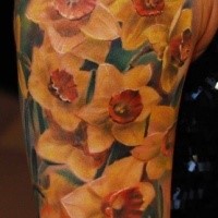 Realism style colored flowers tattoo on shoulder