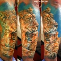 Realism style colored forearm tattoo of lion family