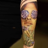 Realism style colored forearm tattoo of woman with flowers