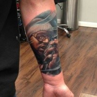 Realism style colored forearm tattoo of old singer