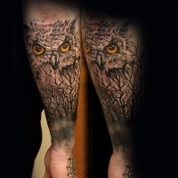 Realism style colored forearm tattoo of owl with trees