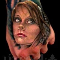 Realism style colored hand tattoo of woman face