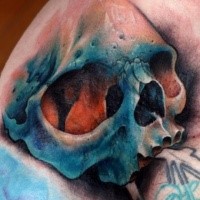 Realism style colored large shoulder tattoo of human skull