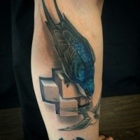 Realism style colored leg tattoo of beautiful bird with stone cross