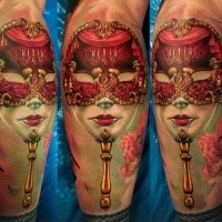 Realism style colored leg tattoo of cool looking mask with flowers